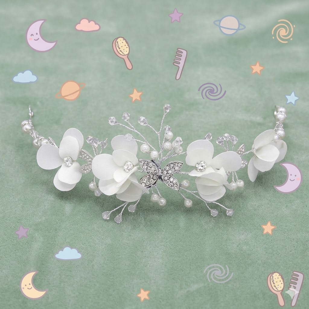 White floral hair accessory with silver accents on a white background