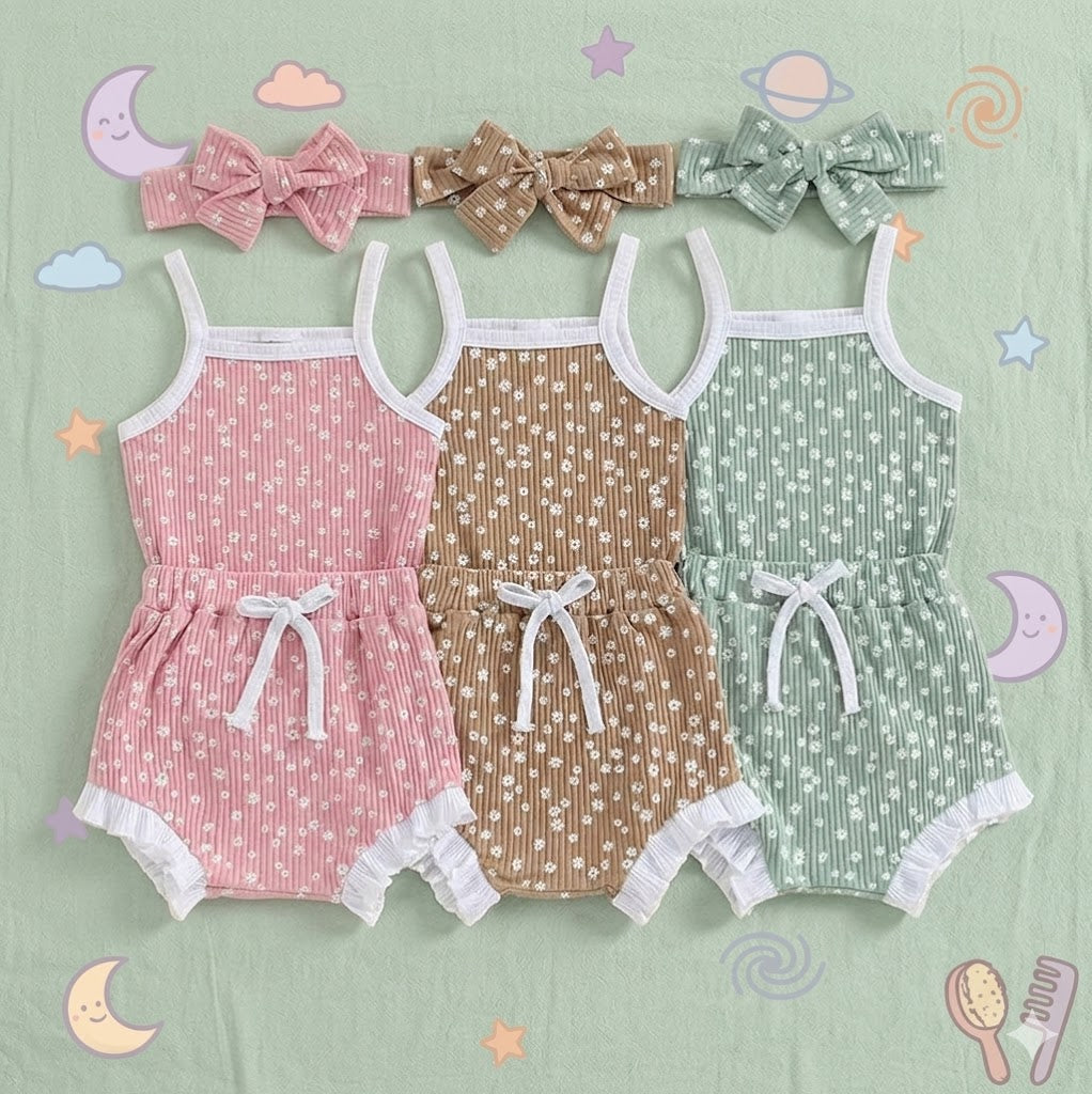 Three baby rompers in pink, brown, and green with matching headbands on a light green background.