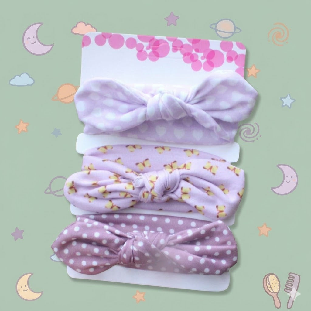 Set of baby headbands with polka dots and floral patterns on a branded card