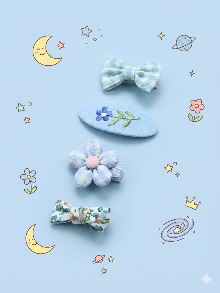 Set of decorative hair clips on a blue background with celestial illustrations.