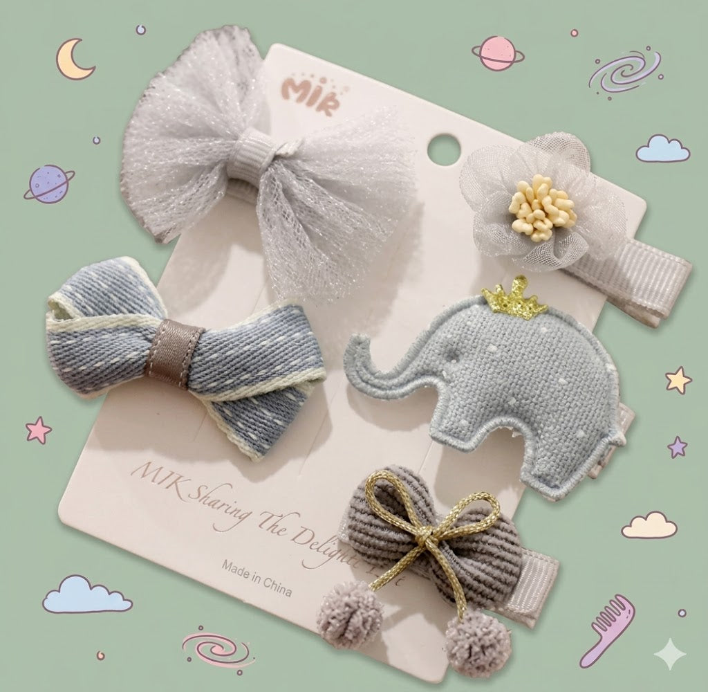 Set of decorative hair accessories including bows and an elephant design on a card.