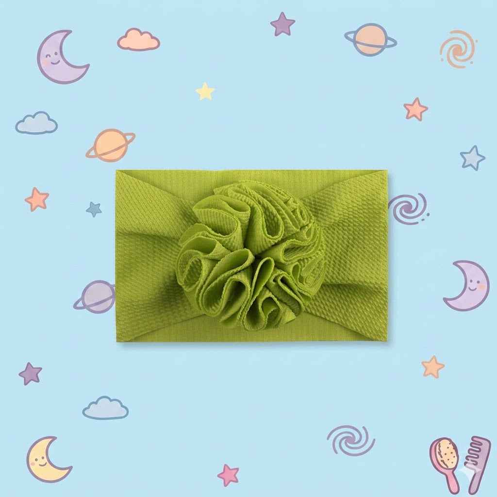 Green knitted headband with a floral design on a blue background