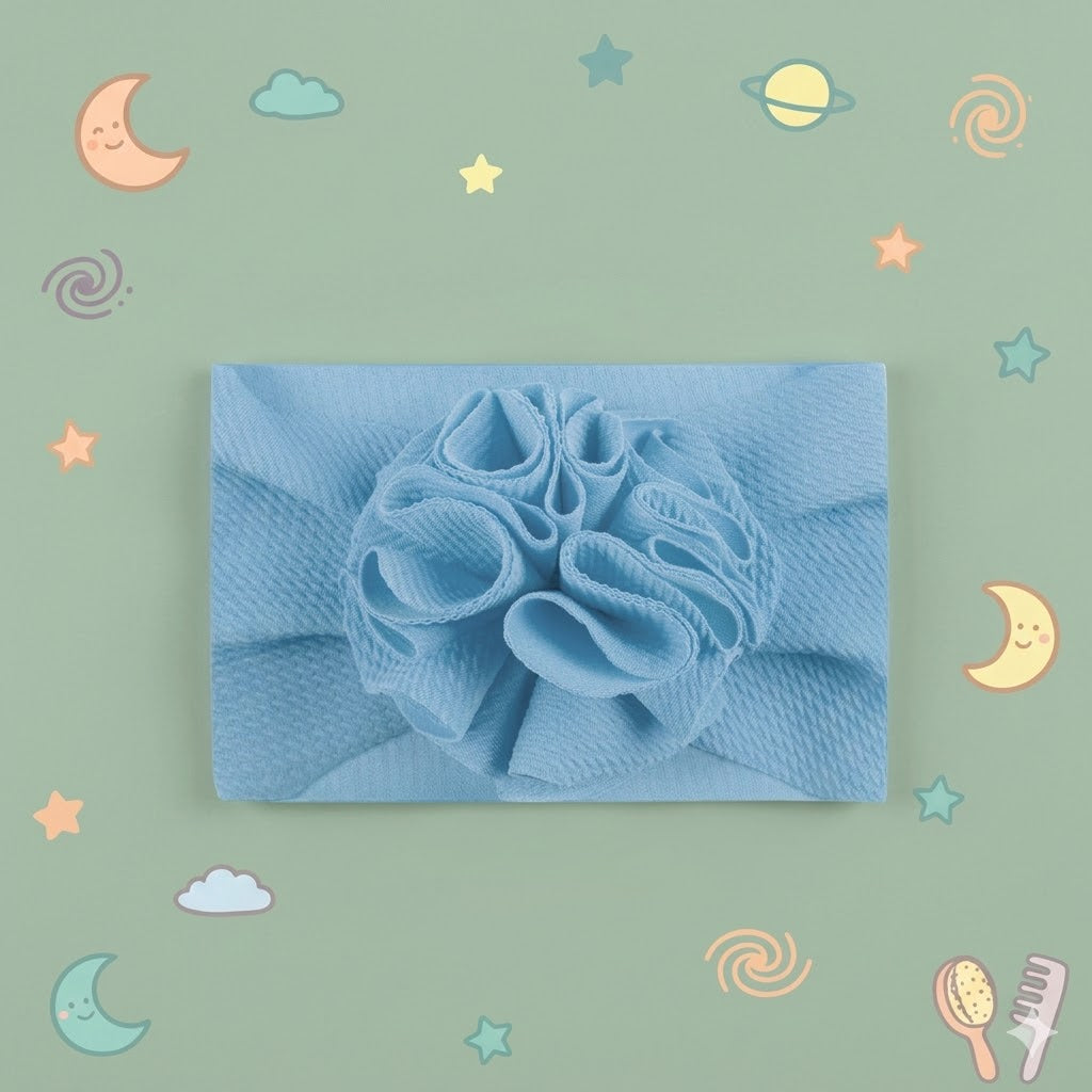 Light blue headband with a decorative bow on a green background