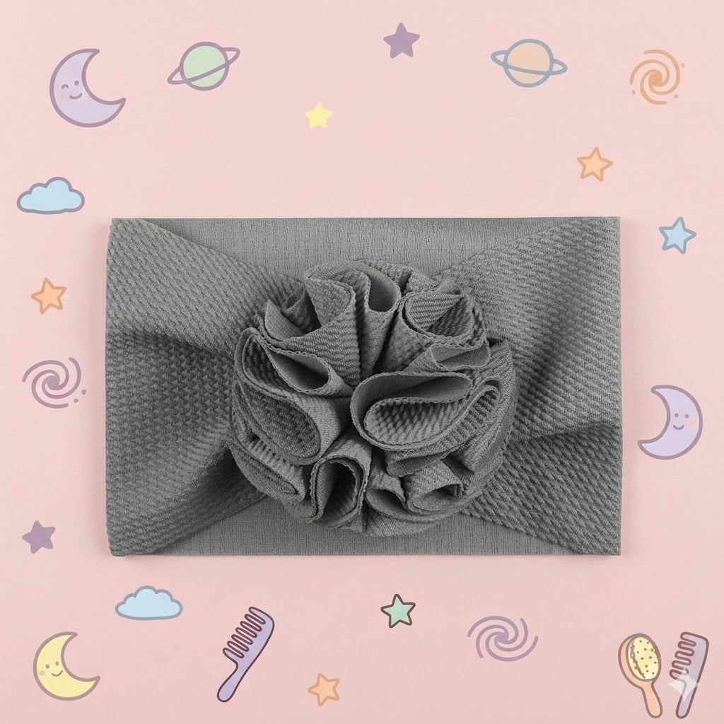 Gray headwrap with a floral design on a pink background