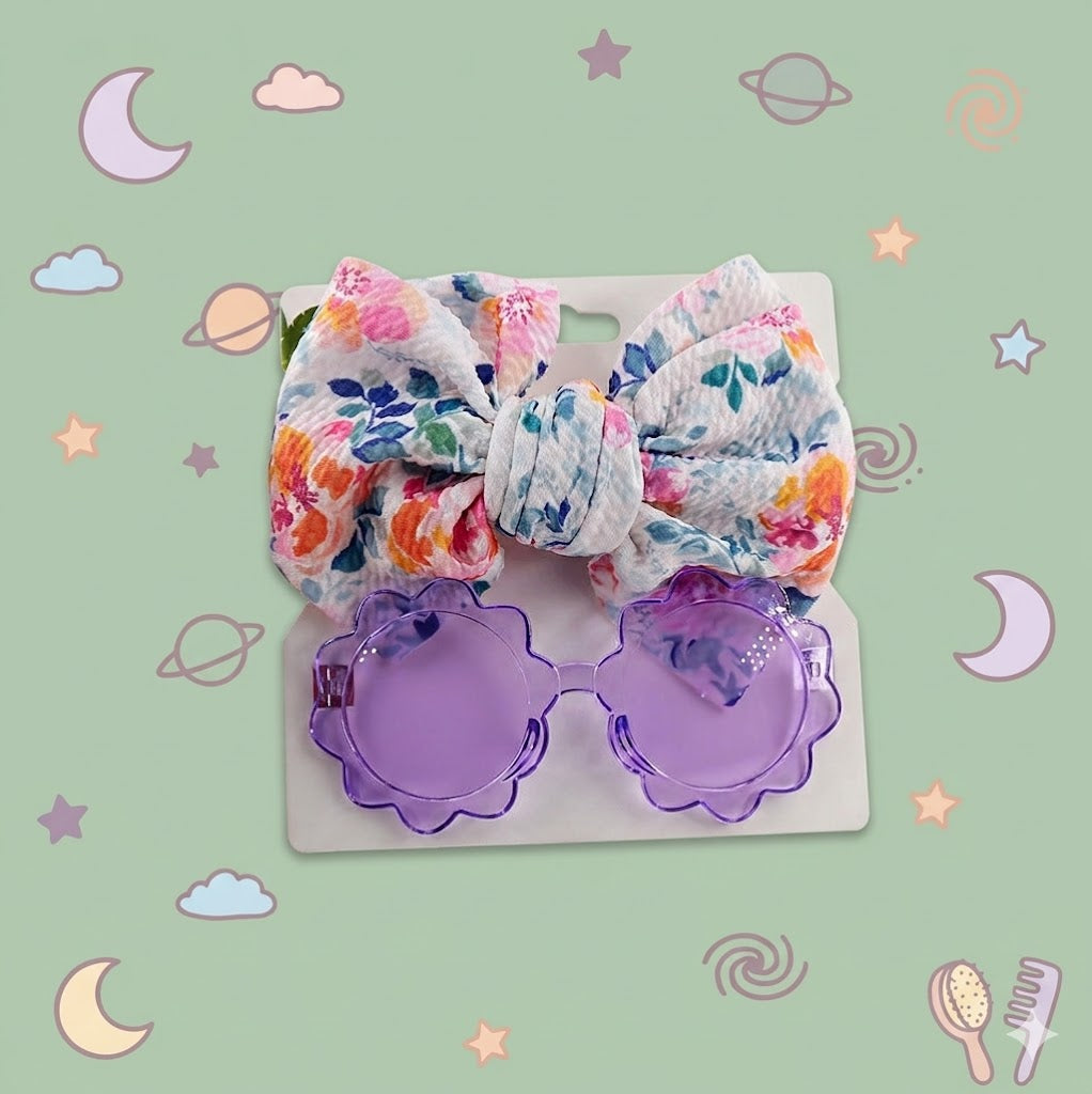 Floral bow and purple sunglasses on a sage background